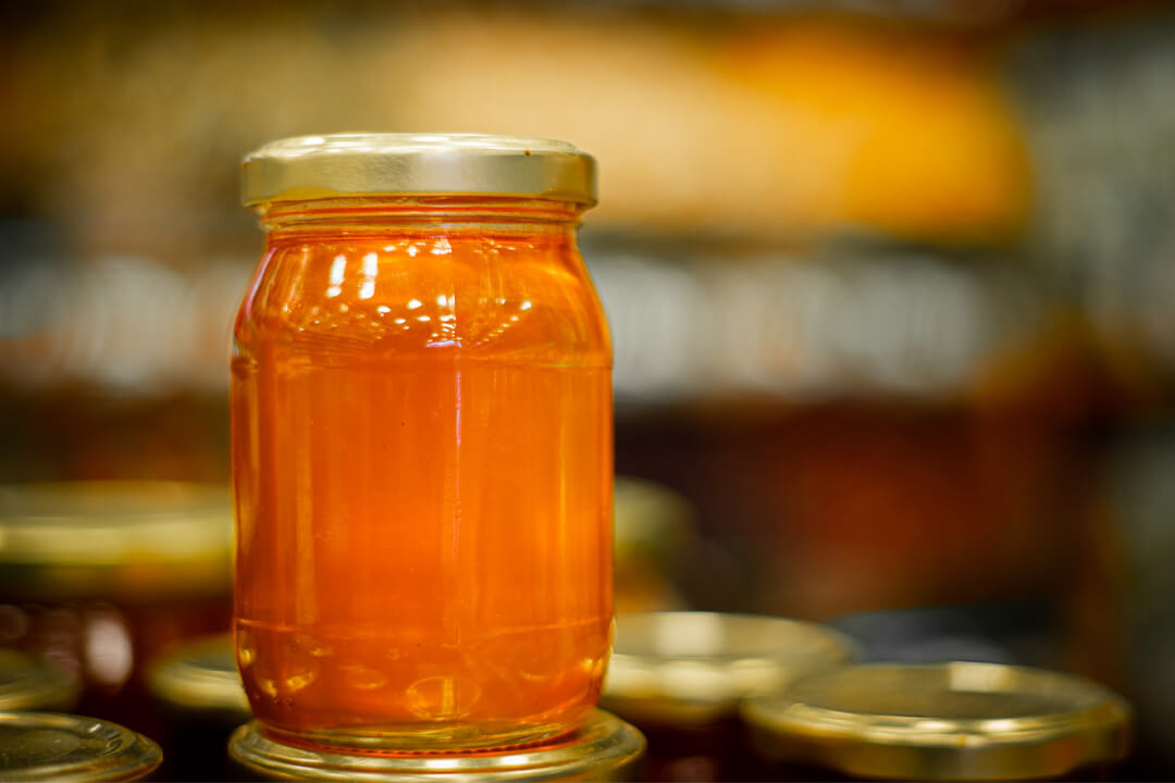 Bottle Of Honey In Mason Jar